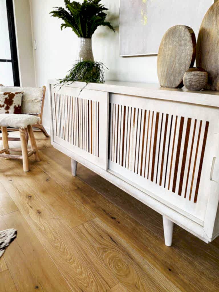 Living room cabinet with pottery and plants on top